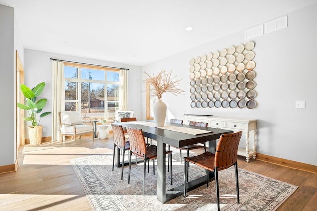 dining area with hardwood / wood-style floors