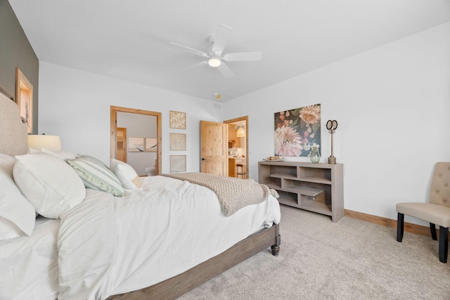 carpeted bedroom with ceiling fan and ensuite bathroom