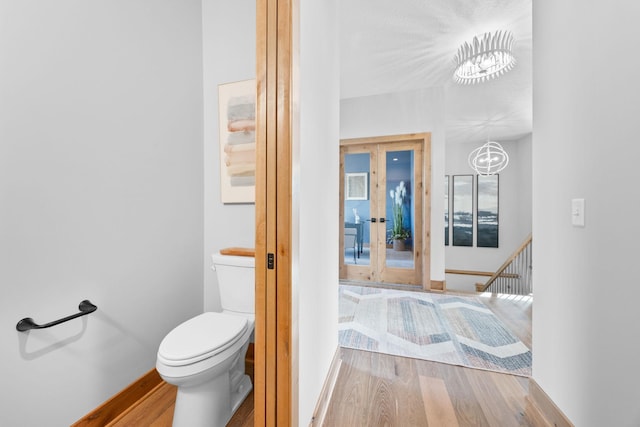 bathroom with hardwood / wood-style flooring and toilet