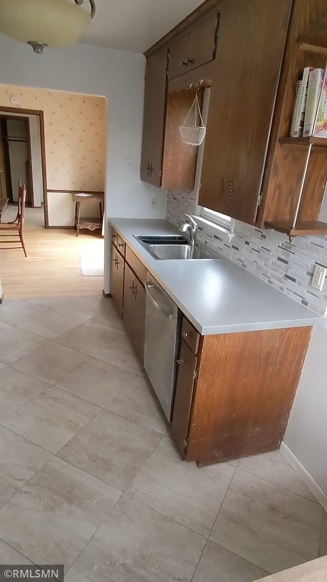 kitchen featuring tasteful backsplash, sink, and stainless steel dishwasher