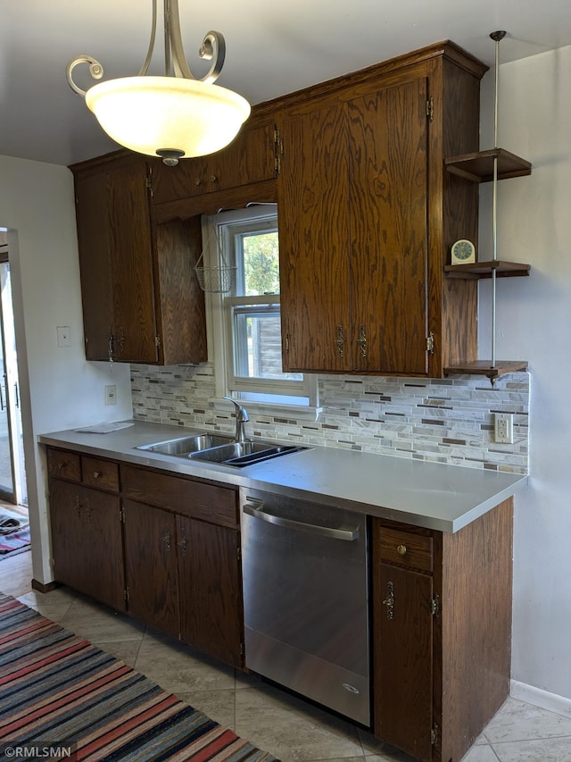 kitchen featuring tasteful backsplash, sink, stainless steel dishwasher, and pendant lighting