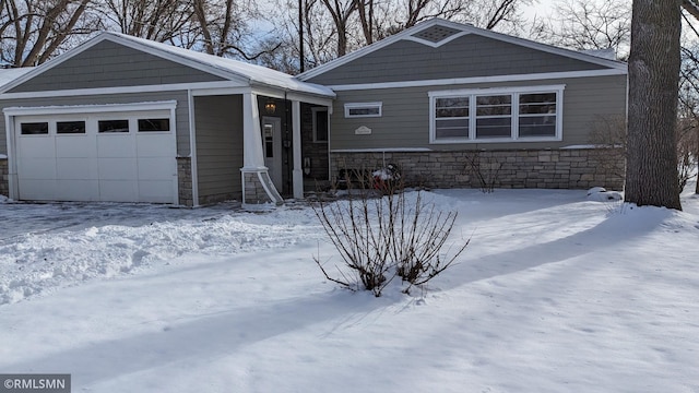 view of front of property with a garage and stone siding