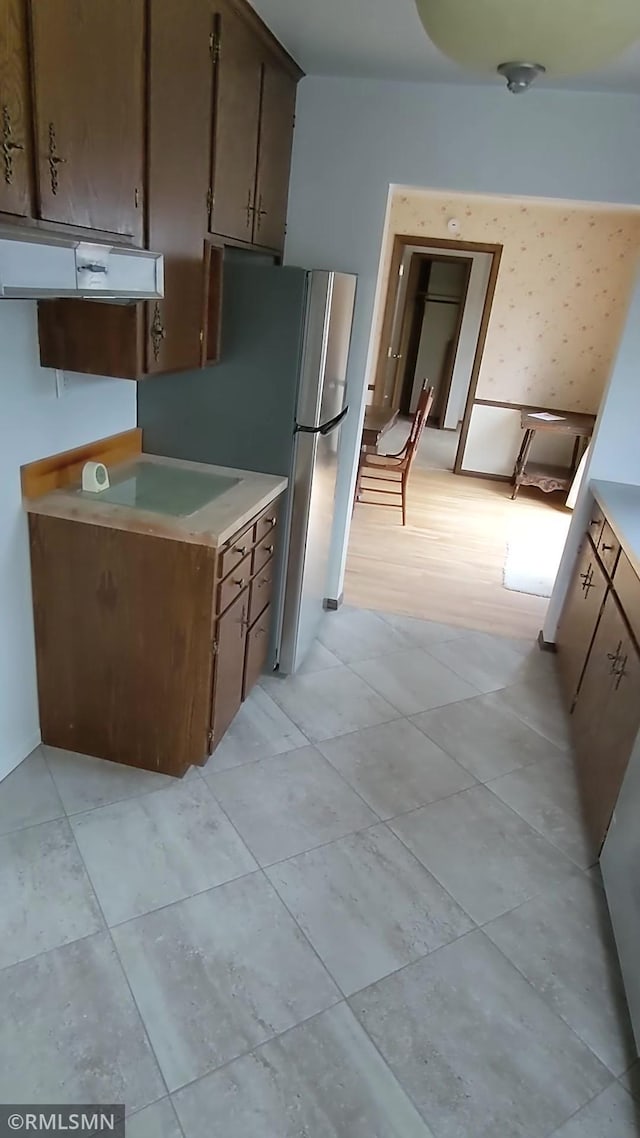 3501 Virginia Ave S, Saint Louis Park, MN 55426 - kitchen featuring under cabinet range hood, light countertops, and light tile patterned flooring