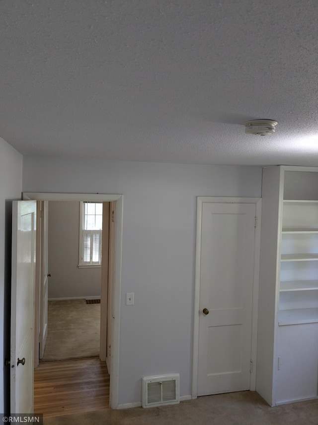 3501 Virginia Ave S, Saint Louis Park, MN 55426 - spare room featuring a textured ceiling, a smoke detector, wood finished floors, and baseboards