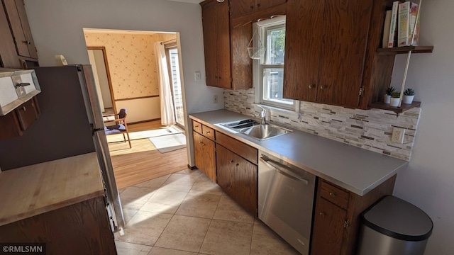 3501 Virginia Ave S, Saint Louis Park, MN 55426 - kitchen featuring stainless steel appliances, a sink, decorative backsplash, open shelves, and light countertops
