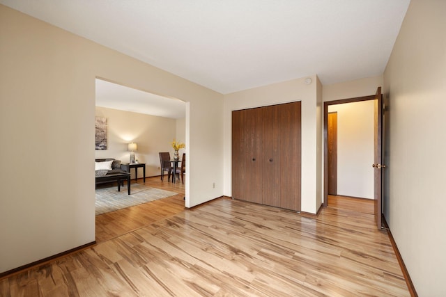 bedroom featuring light hardwood / wood-style flooring and a closet