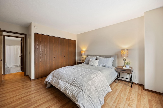 bedroom featuring light hardwood / wood-style floors and a closet