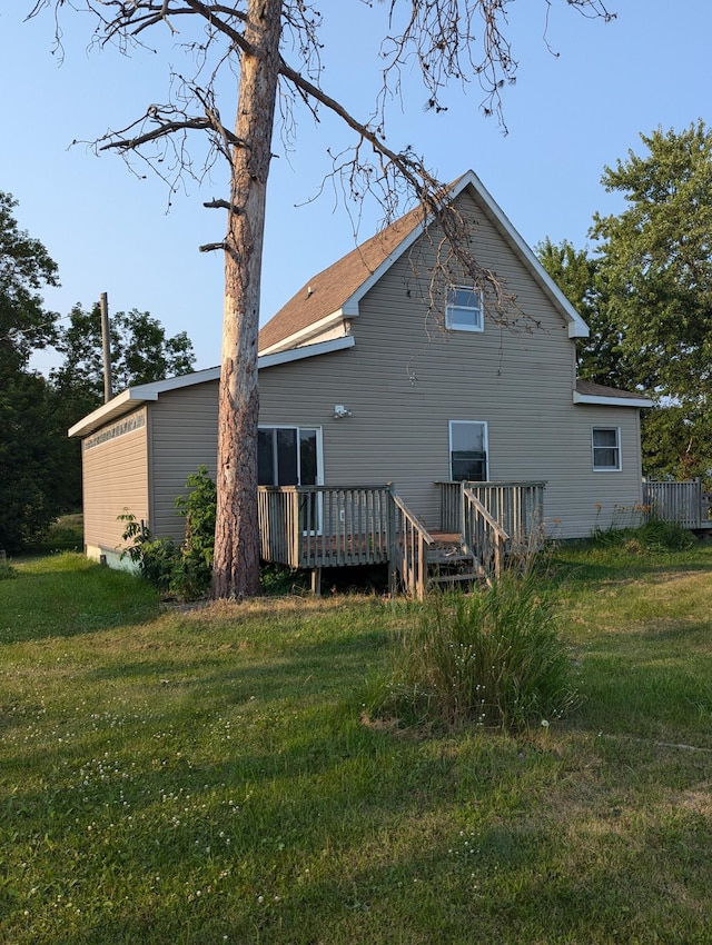 back of property featuring a yard and a deck