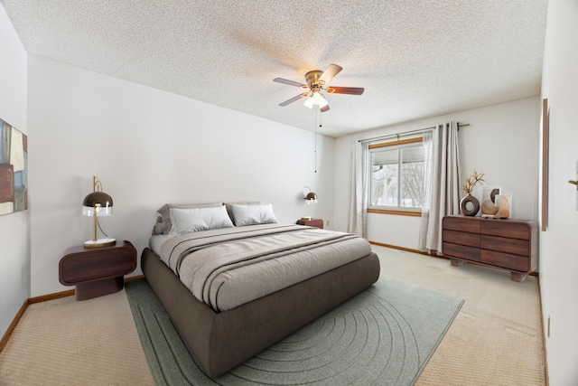 bedroom with a textured ceiling, baseboards, a ceiling fan, and light colored carpet