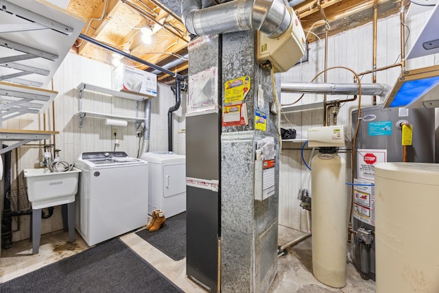 interior space with a sink, heating unit, water heater, and washer and dryer