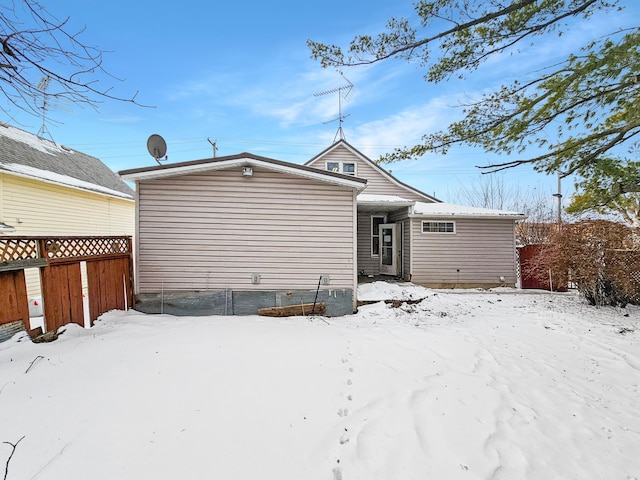 view of snow covered rear of property