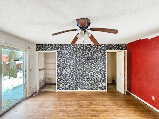 spare room featuring ceiling fan, hardwood / wood-style floors, and a textured ceiling