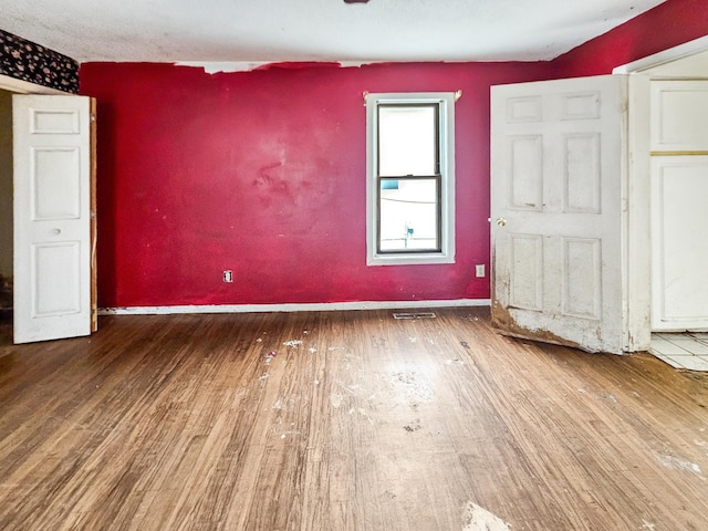 unfurnished bedroom featuring hardwood / wood-style floors