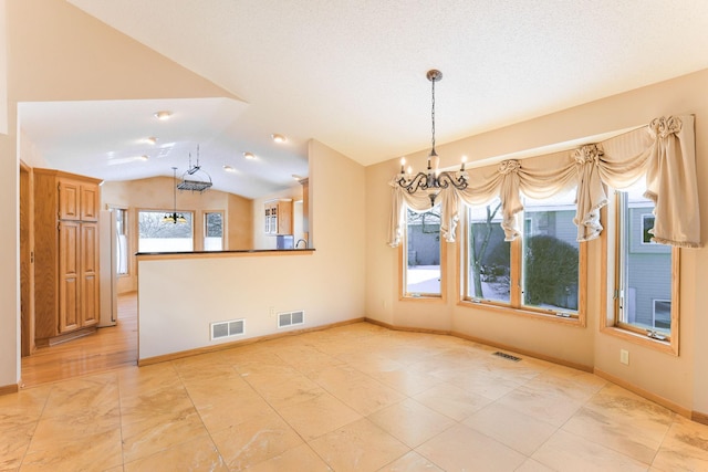 interior space with an inviting chandelier and vaulted ceiling