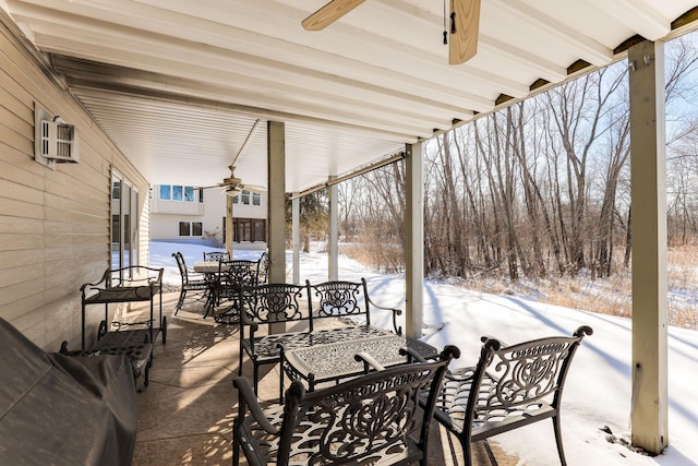 snow covered patio featuring ceiling fan