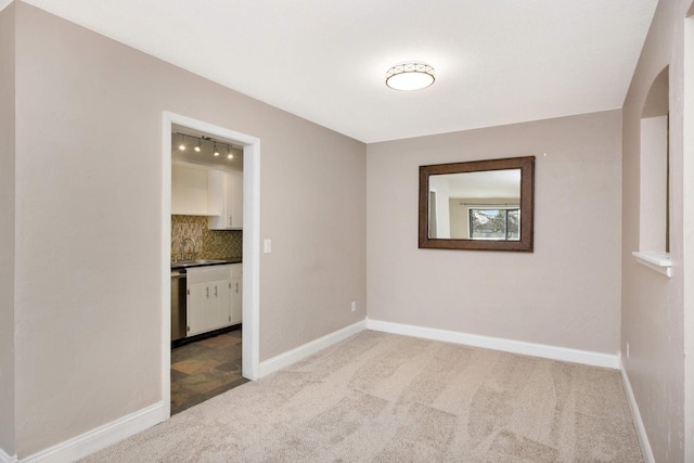 carpeted spare room with sink