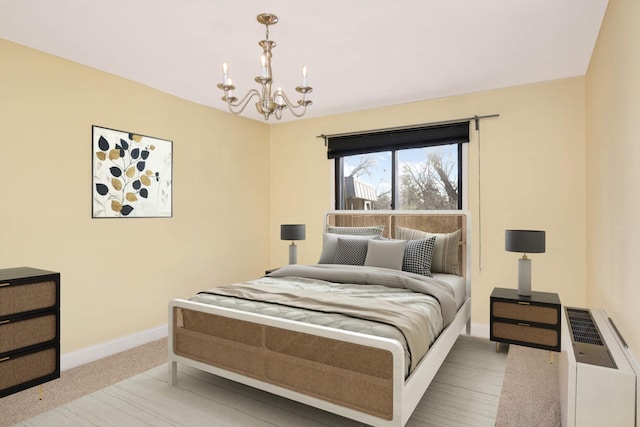 carpeted bedroom featuring an inviting chandelier