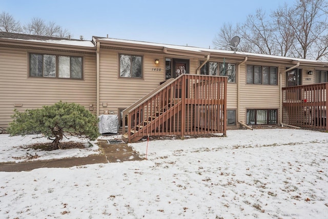 view of snow covered back of property