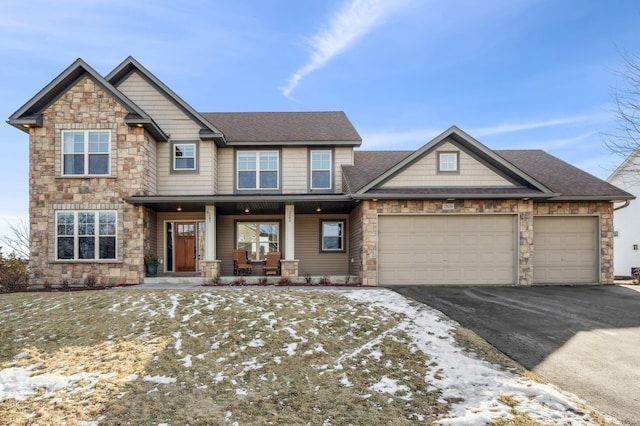 craftsman inspired home with a porch and a garage