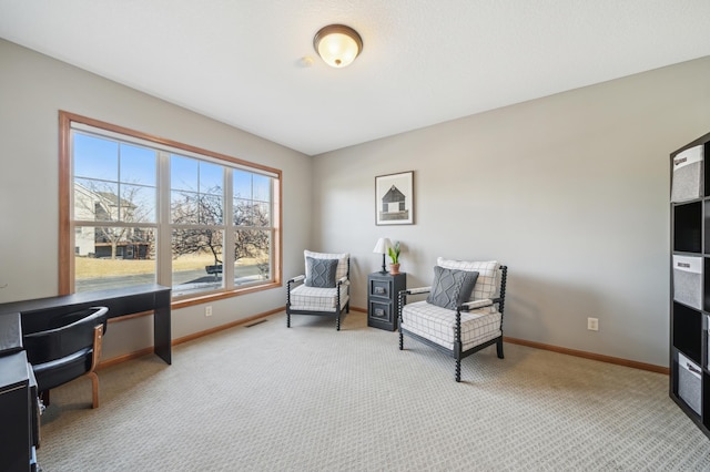 sitting room featuring carpet flooring, visible vents, and baseboards