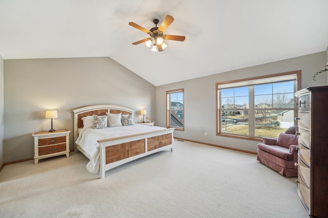 bedroom with vaulted ceiling, ceiling fan, baseboards, and light colored carpet