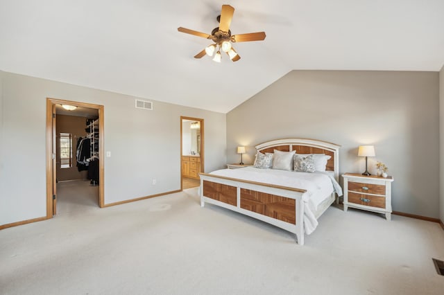 bedroom featuring light carpet, visible vents, baseboards, vaulted ceiling, and a spacious closet