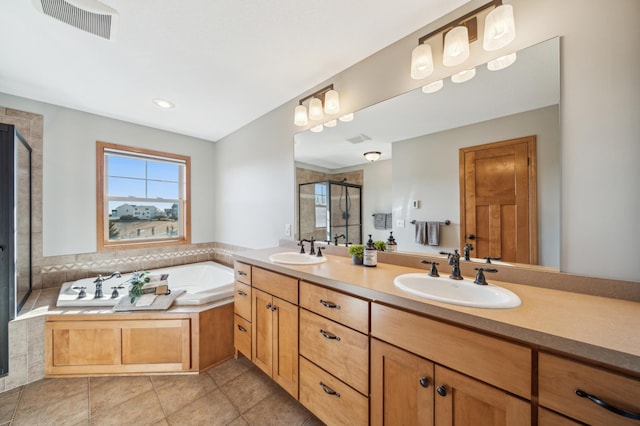 full bathroom featuring a bath, double vanity, visible vents, and a sink