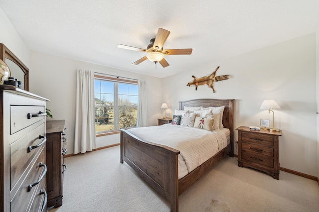 bedroom featuring light carpet, ceiling fan, and baseboards