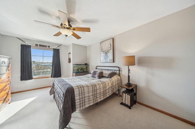 bedroom with baseboards, a ceiling fan, and light colored carpet