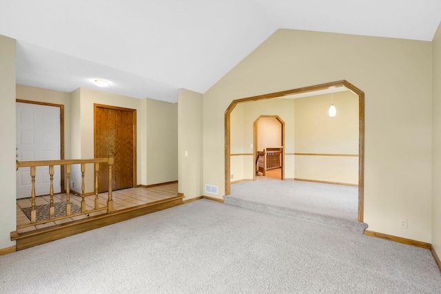 5639 Park Place Dr, Shoreview, MN 55126 - unfurnished room with carpet flooring, baseboards, lofted ceiling, and arched walkways
