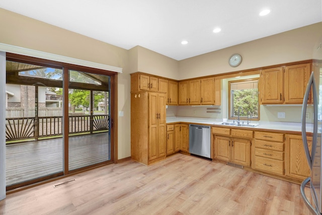 5639 Park Place Dr, Shoreview, MN 55126 - kitchen with stainless steel dishwasher, light countertops, a sink, light wood-type flooring, and recessed lighting