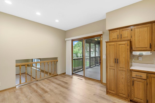 5639 Park Place Dr, Shoreview, MN 55126 - kitchen with light wood-style floors, recessed lighting, light countertops, brown cabinets, and baseboards