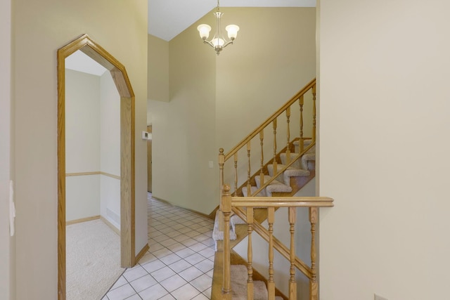 5639 Park Place Dr, Shoreview, MN 55126 - foyer featuring arched walkways, light tile patterned flooring, a chandelier, baseboards, and lofted ceiling