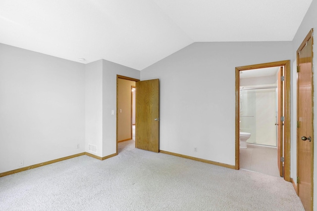 5639 Park Place Dr, Shoreview, MN 55126 - unfurnished bedroom with vaulted ceiling, light colored carpet, baseboards, and ensuite bath