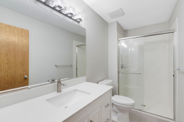 5639 Park Place Dr, Shoreview, MN 55126 - bathroom featuring vanity, a shower stall, and toilet