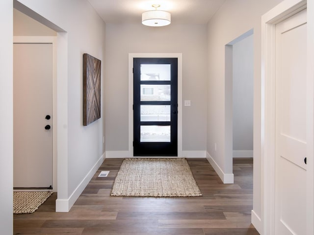 foyer entrance with dark hardwood / wood-style floors