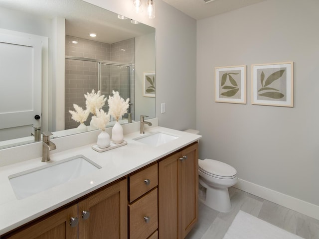 bathroom with tile patterned floors, vanity, toilet, and an enclosed shower