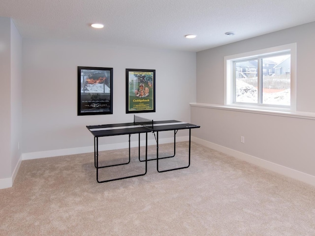 office area with light colored carpet and a textured ceiling