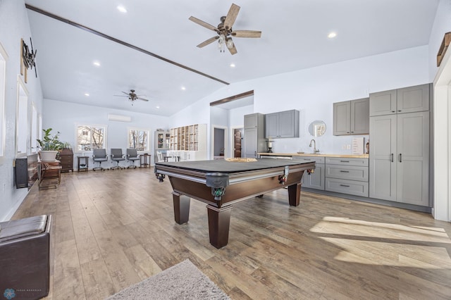 playroom with ceiling fan, wood-type flooring, high vaulted ceiling, and sink