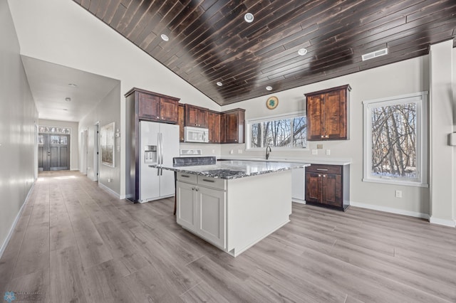 25379 Deerpath Loop, Pelican Rapids, MN 56572 - kitchen with white microwave, refrigerator with ice dispenser, baseboards, a kitchen island, and wood ceiling