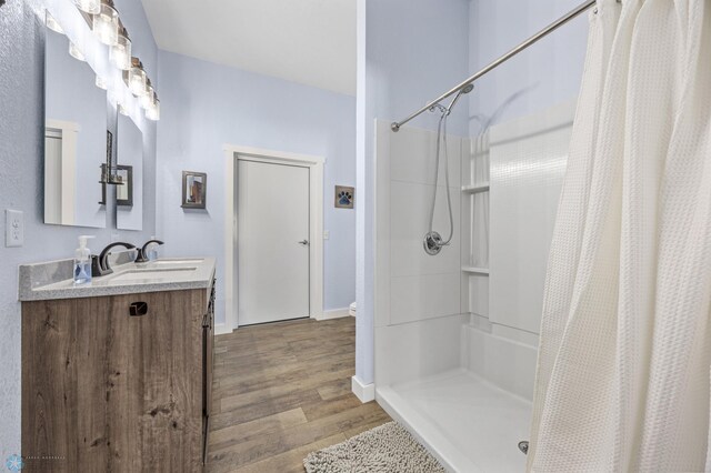 25379 Deerpath Loop, Pelican Rapids, MN 56572 - bathroom featuring wood finished floors, baseboards, curtained shower, and vanity
