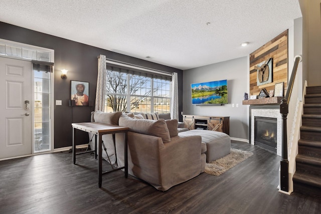 living room with dark wood-type flooring and a textured ceiling