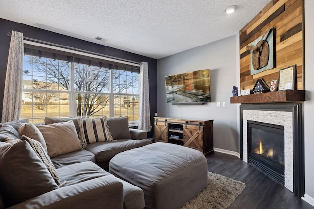 living room with dark hardwood / wood-style floors and a textured ceiling