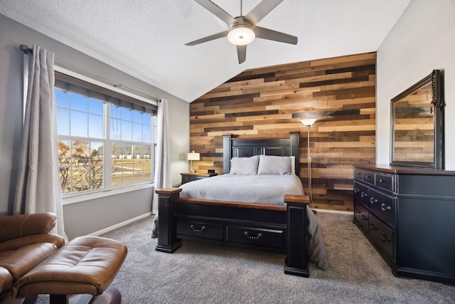 carpeted bedroom with lofted ceiling, ceiling fan, a textured ceiling, and wood walls