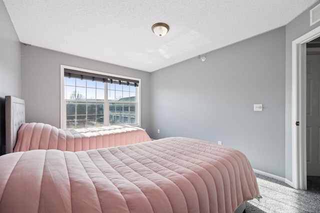 carpeted bedroom with a textured ceiling