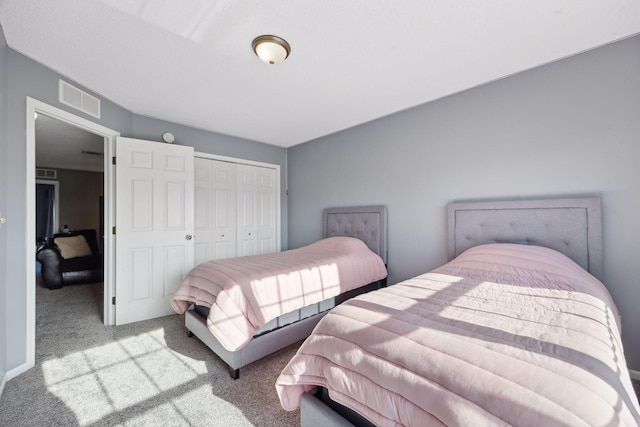 bedroom with light colored carpet and a closet