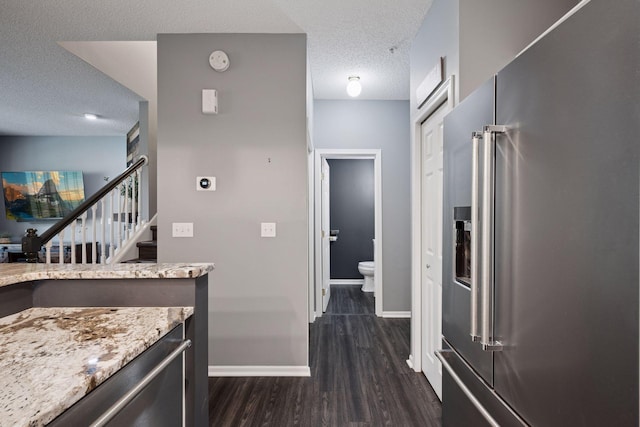 7316 Bunker Lake Blvd NW, Ramsey, MN 55303 - kitchen with high quality fridge, a textured ceiling, dark wood-style floors, baseboards, and light stone counters