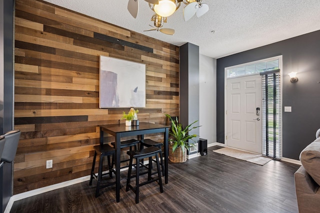 7316 Bunker Lake Blvd NW, Ramsey, MN 55303 - dining area featuring wooden walls, baseboards, dark wood-type flooring, a chandelier, and a textured ceiling