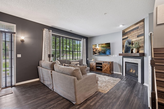 7316 Bunker Lake Blvd NW, Ramsey, MN 55303 - living room featuring a textured ceiling, baseboards, dark wood-type flooring, a large fireplace, and stairway