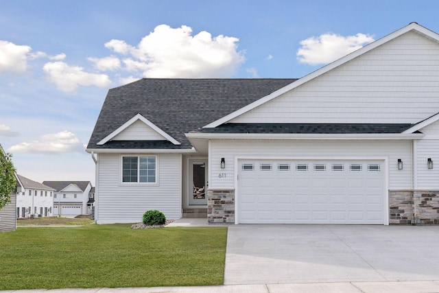 view of front of property with a garage and a front lawn